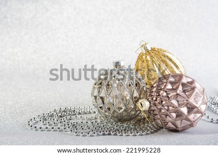 Festive beautiful christmas decoration on abstract silver glitter background. three objects
