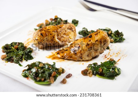 cooked rabbit meat with spinach and raisins
