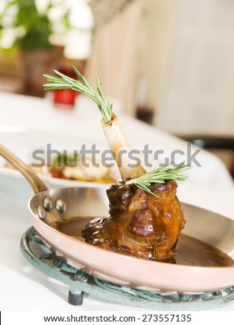 Caramelized Lamb knee in sauce in the pan