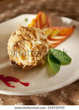 Delicious restaurant dessert, fried ice cream served with whipped cream and fruit coulis
