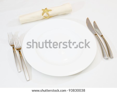 Knife, fork, white plate and napkin in ring
