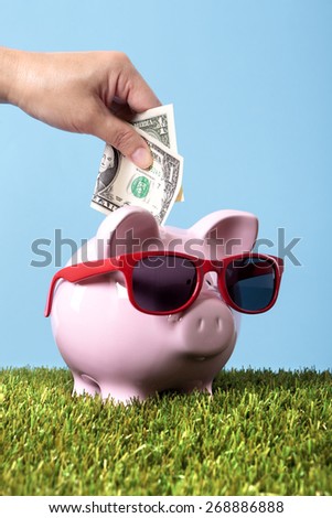 Vacation money saving plan, piggy bank, sunglasses