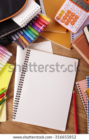 School desk background with open folded notepad, copy space, vertical