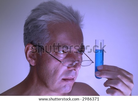 Scientist examining an experiment. Self portrait. Blue filter and dramatic lighting.