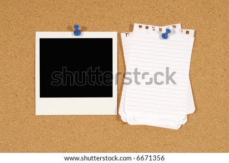 Cork notice or bulletin board with blank polaroid style instant camera photo print and several sheets of untidy torn notepaper. Space for copy.