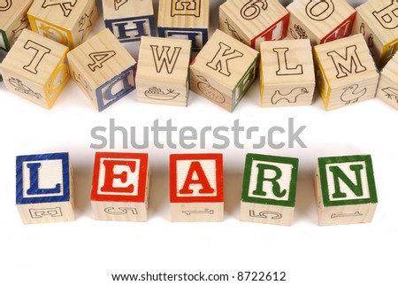 The word Learn with an assortment of childhood alphabet or letter blocks (please note that the blocks are naturally rustic and have numerous imperfections).
