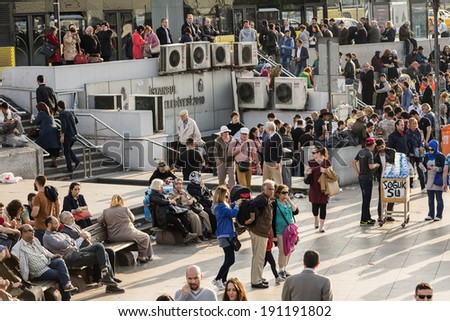ISTANBUL, TURKEY - MAY 02, 2014:crowd in Eminou District. Eminonu Square, people eating fish. Eminonu Square is so crowded on day.People watching golden horn.