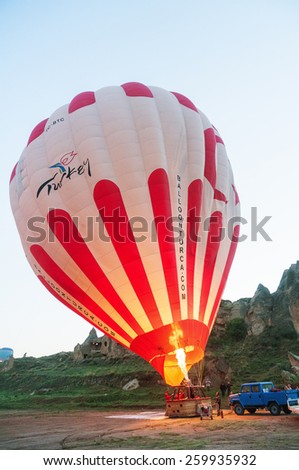 NEVSEHIR, TURKEY - MAY 08, 2012:Ground Crews torch the flame and heat up the balloon to inflate Hot Air Balloon before launching.