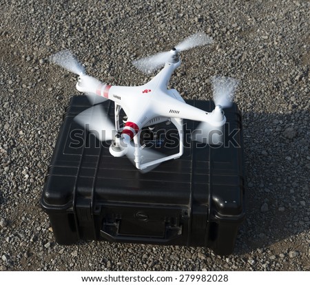 ISTANBUL, TURKEY - MAY 19 ,2015: Operator holding remote control .A stationary Phantom quadcopter and remote controller, manufactured by the company DJI Innovations.