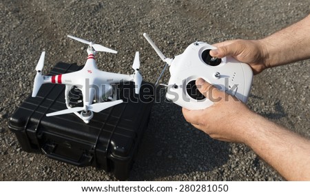 ISTANBUL, TURKEY - MAY 19 ,2015: Operator holding remote control .A stationary Phantom quadcopter and remote controller, manufactured by the company DJI Innovations.