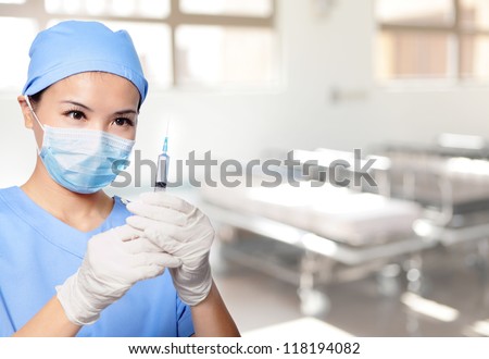 surgery woman doctor holding syringe needle in hospital, asian female model