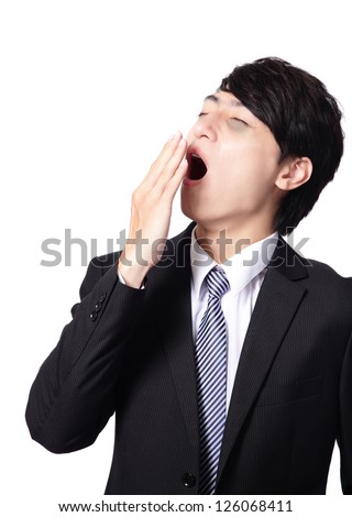 overworked business man yawning with black rim of eye, face in profile,  isolated on white background, model is a asian people