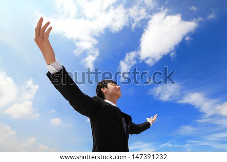 Business man carefree outstretched arms with sky and cloud, asian people