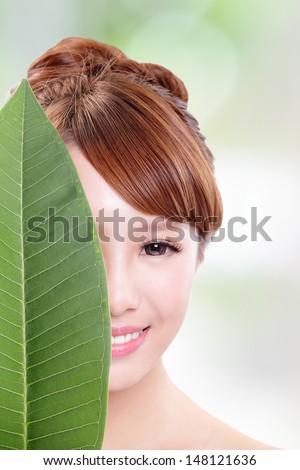 beautiful woman face portrait with green leaf , concept for skin care or organic cosmetics , asian beauty model