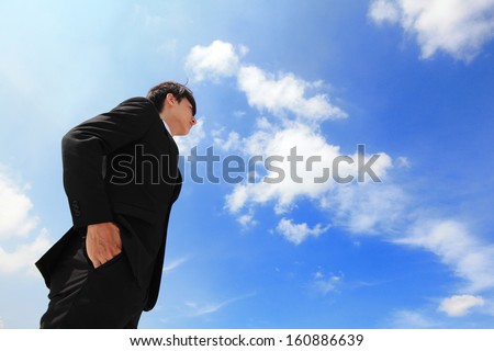Successful handsome business man purposefully looking away with blue sky, mode is a asian male