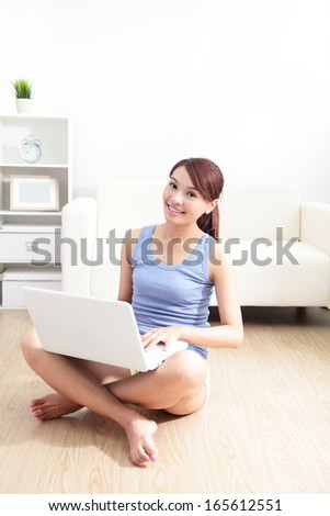 woman using laptop on sofa in the living room, asian beauty