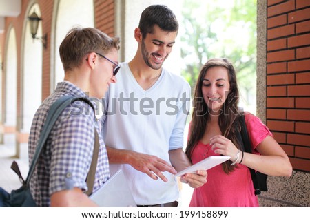 Happy College students using tablet pc on campus, caucasian