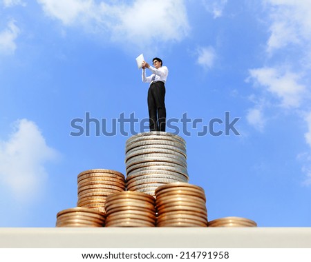Successful business man working and using digital tablet pc on growth money stairs coin with sky