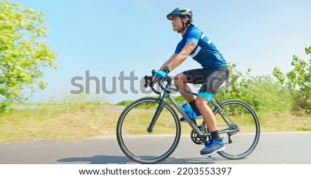 Similar – Image, Stock Photo Young man riding bicycle