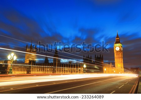 Big Ben and London at night with the lights of the cars passing by, the most prominent symbols of both London and England