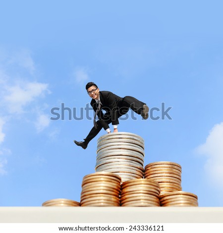 business concept - business man run and jump on money stairs with blue sky background, asian male