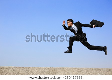 business man jump and run with blue sky background, full length, asian male