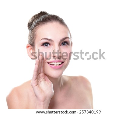 Close up portrait of a smiling skin care woman whispers (tells) a gossip. Isolated on white background, caucasian beauty