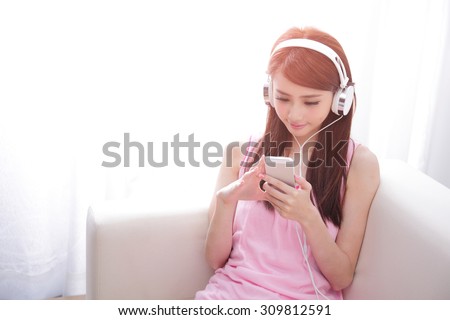 Young beautiful woman enjoying the music at home, asian beauty