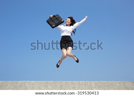 Successful business woman jump and run with blue sky background, full length, asian