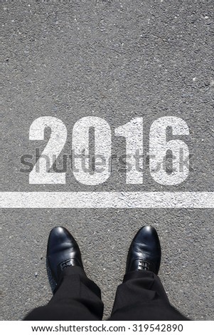 Start to new year 2016 - top view of business man walking on the road