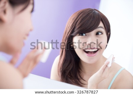 Close up of Smile woman remove makeup by Cleansing Cotton and look mirror. asian beauty