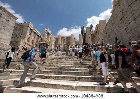 ATHENS, GREECE - JUNE 26: Tourists in famous old city Acropolis on June 26, 2011 in Athens, Greece. Its construction began in 447 BC in the Athenian Empire. It was completed in 438 BC