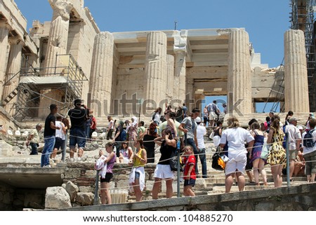 ATHENS, GREECE - JUNE 26: Tourists in famous old city Acropolis on June 26, 2011 in Athens, Greece. Its construction began in 447 BC in the Athenian Empire. It was completed in 438 BC