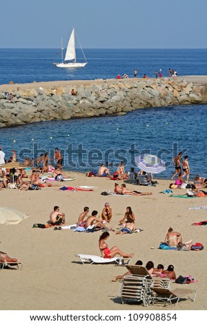 CANNES, FRANCE - JULY 24: People sunbathing at Cannes Beach on July 24, 2006 in Cannes, France. Cannes beachfront, considered between 5 best urban beach of the Europe.