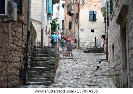 KOTOR, MONTENEGRO - SEPTEMBER 6: People walking at Kotor old city street on September 6, 2012 in Kotor, Montenegro. Kotor is part of the UNESCO World Heritage Site.