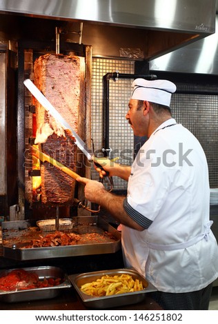 ISTANBUL, TURKEY - JUNE 29: A chef cutting traditional Turkish food Doner Kebab in the restaurant on June 29, 2011 in Istanbul, Turkey.