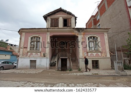 ALASEHIR, TURKEY - APRIL 27: A man walking behind old building at ancient city of Alasehir on April 27, 2011 in Manisa, Turkey. Alasehir in antiquity and the middle ages known as Philadelphia.