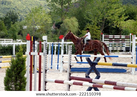 ISTANBUL, TURKEY - SEPTEMBER 2: Turkish female horse rider on horse overcomes the obstacle on September 2, 2005 in Istanbul, Turkey.
