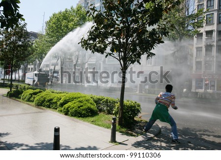 ISTANBUL, TURKEY - MAY 1: International Workers Day. Police throwing pressurized water at protester on May 1, 2008 in Istanbul, Turkey. Taksim Square is the center of the protest and celebrations.
