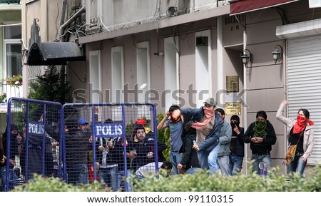 ISTANBUL, TURKEY - MAY 1: International Workers Day. Protesters throwing stone at Riot Police on May 1, 2008 in Istanbul, Turkey. Taksim Square is the center of the protest and celebrations.