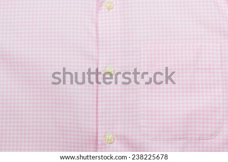 Pink scottish men\'s shirt texture with buttons and pocket; Close up