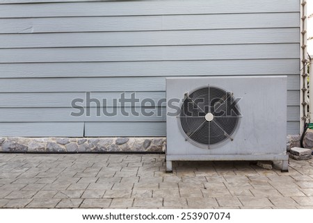 Air conditioning compressor with grey wall background