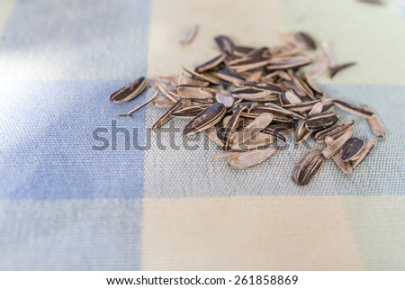 A pile of sunflower seed shells on a table