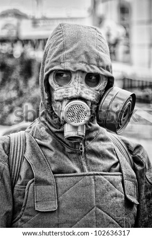 portrait of man in gas mask on industrial background
