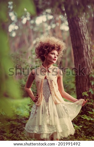 Portrait of romantic woman in fairy forest.