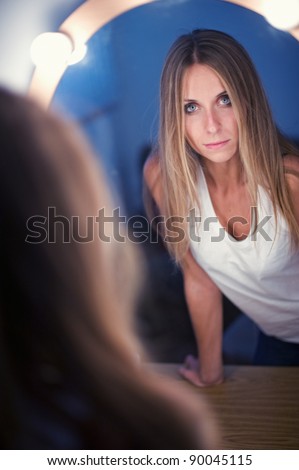 model looking at her self in the mirror