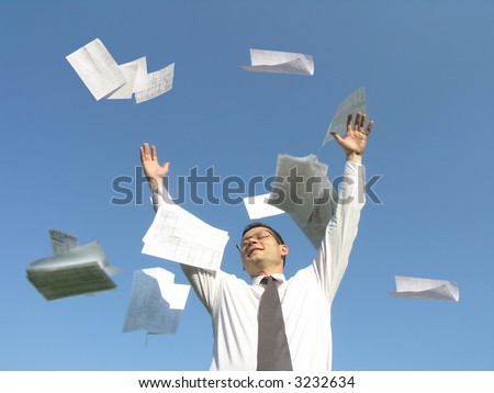 A young businessman throwing away his papers