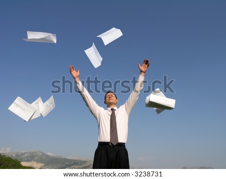 A young businessman throwing away his papers