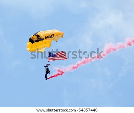 EAU CLAIRE, WI - JUNE 6: A member of the U.S. Army Golden Knights parachute team on her descent with a United States flag at the Chippewa Valley Airshow in Eau Claire, WI on June 6, 2010.
