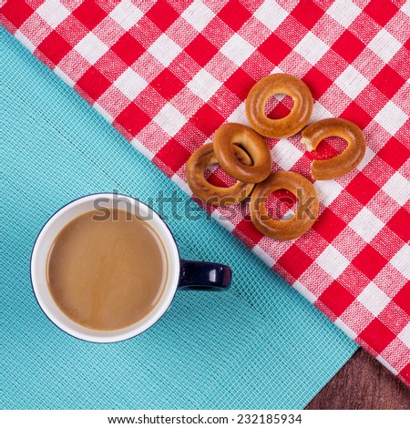 A cup of coffee on the table cuisine. Kitchen table with towels, napkins, coffee and bagels. Refreshments for a cup of coffee. Diet